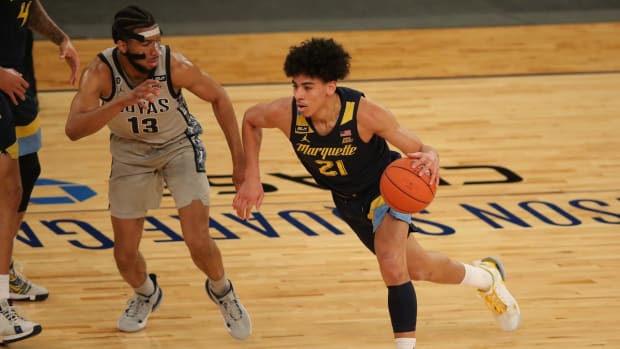 Mar 10, 2021; New York, NY, USA; Marquette Golden Eagles guard D.J. Carton (21) drives with the ball against Georgetown Hoyas guard Donald Carey (13) during the first half of a Big East conference tournament game at Madison Square Garden. Mandatory Credit: Brad Penner-USA TODAY Sports